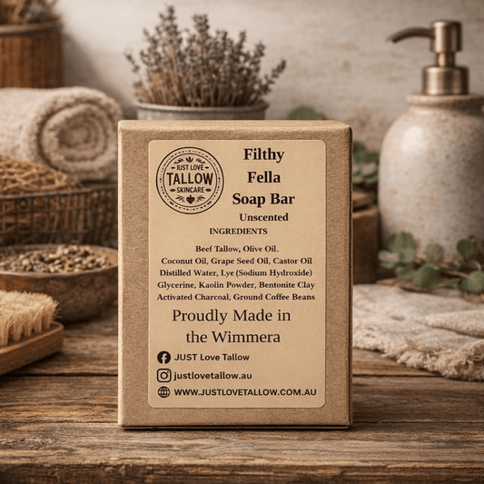 Box of Just Love Tallow soap bar on a wooden surface with spa items in the background