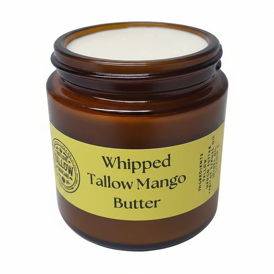 Jar of whipped tallow mango butter with a yellow label on a white background