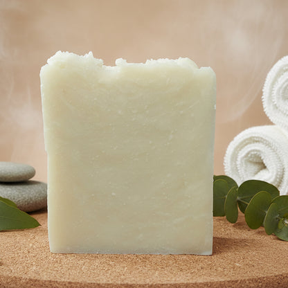 Rectangular block of light-colored soap on a cork surface with a neutral background