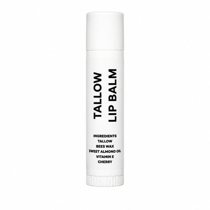 A single white tube of Tallow Lip Balm with black text, standing upright on a wrinkled light gray fabric background.