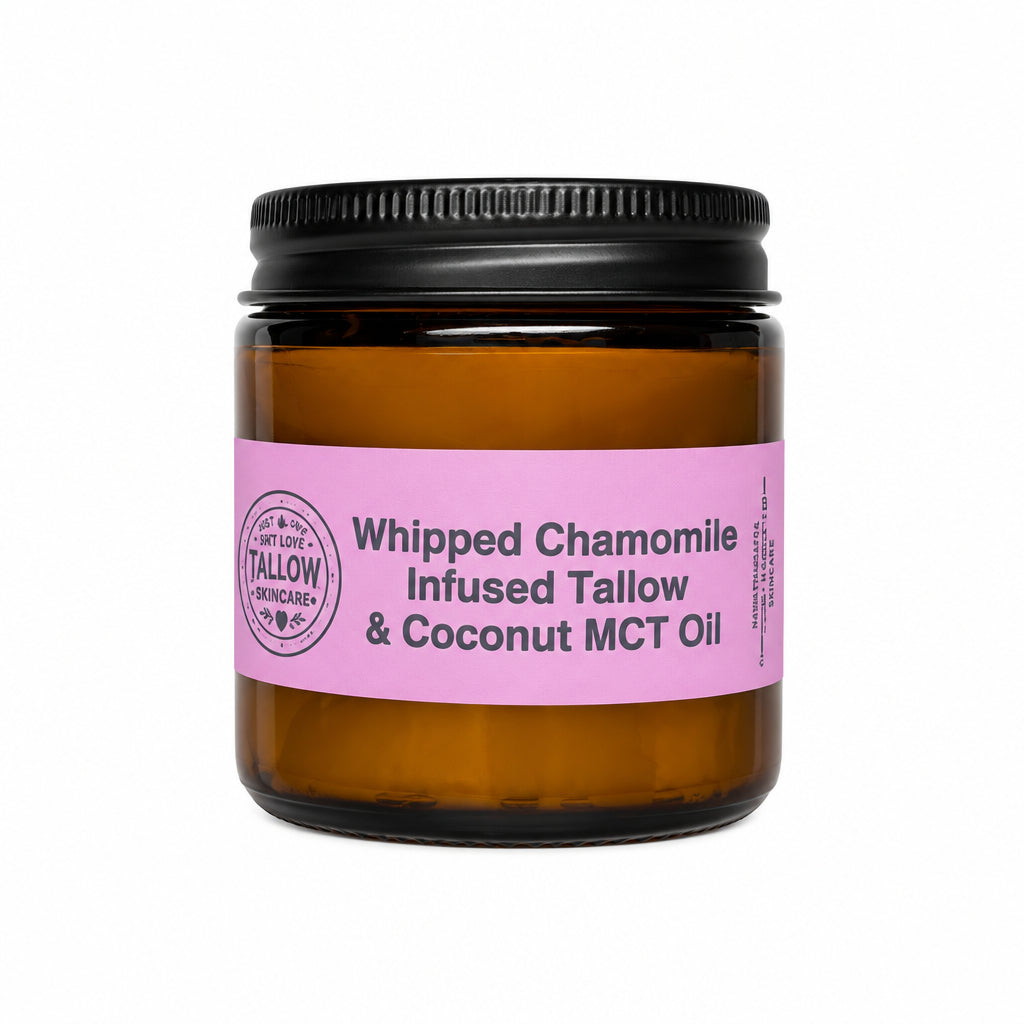 An amber glass jar with a black screw cap and a pink label reading 'Whipped Chamomile Infused Tallow & Coconut MCT Oil', set against a white fabric backdrop.