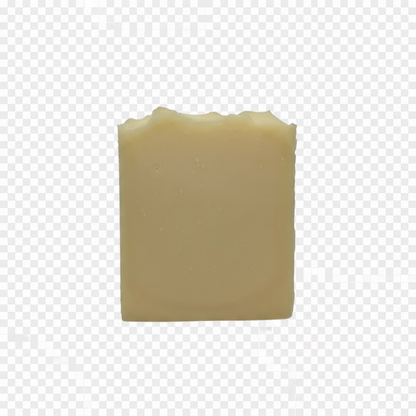 A single rectangular bar of pale yellow soap with a rustic, unevenly chipped top, standing upright on a white fabric background.