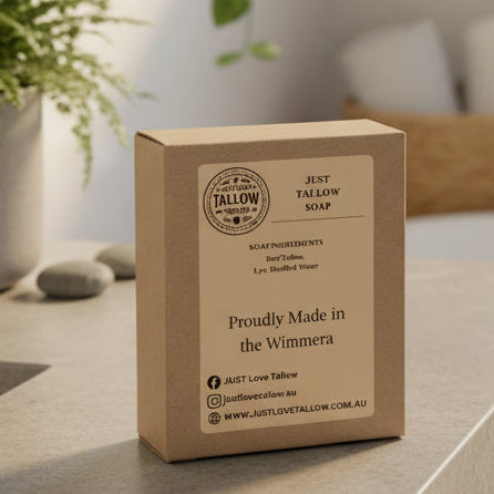 Kraft paper soap packaging with 'Just Tallow' branding and product details on a gray background
