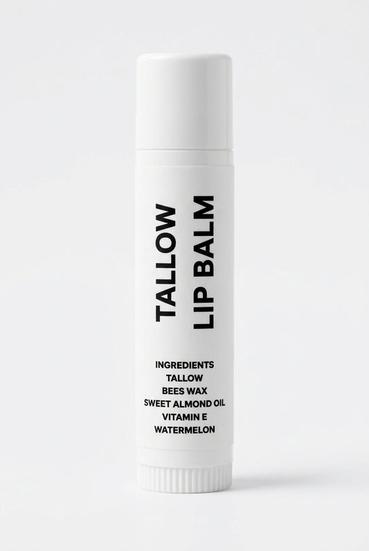 A single white tube of Tallow Lip Balm with black text, standing upright on a wrinkled light gray fabric background.
