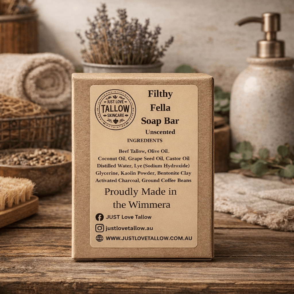 Box of Just Love Tallow soap bar on a wooden surface with spa items in the background