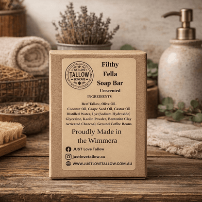 Box of Just Love Tallow soap bar on a wooden surface with spa items in the background