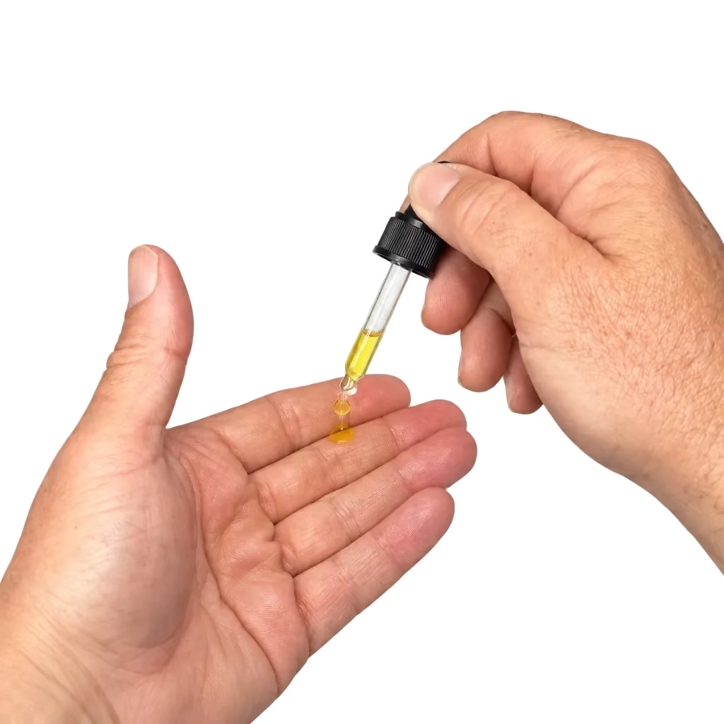 A close-up of a person's hands holding a small dropper bottle and applying a clear liquid to the other hand over a white surface.