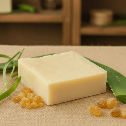 Bar of soap with aloe vera leaves and gel on a textured background