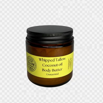 A small amber glass jar of whipped tallow coconut oil body butter with a black lid and a yellow label, set against a light gray fabric background.